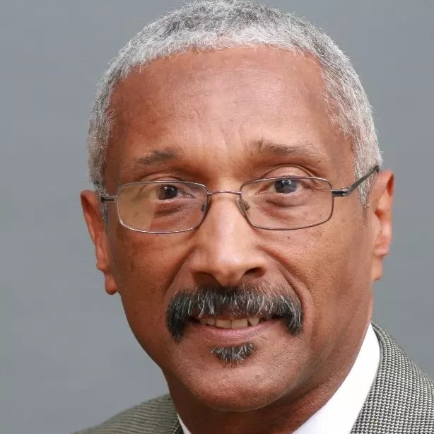 Headshot of Danny Allen, a Black man with short white hair, black moustache, and glasses
