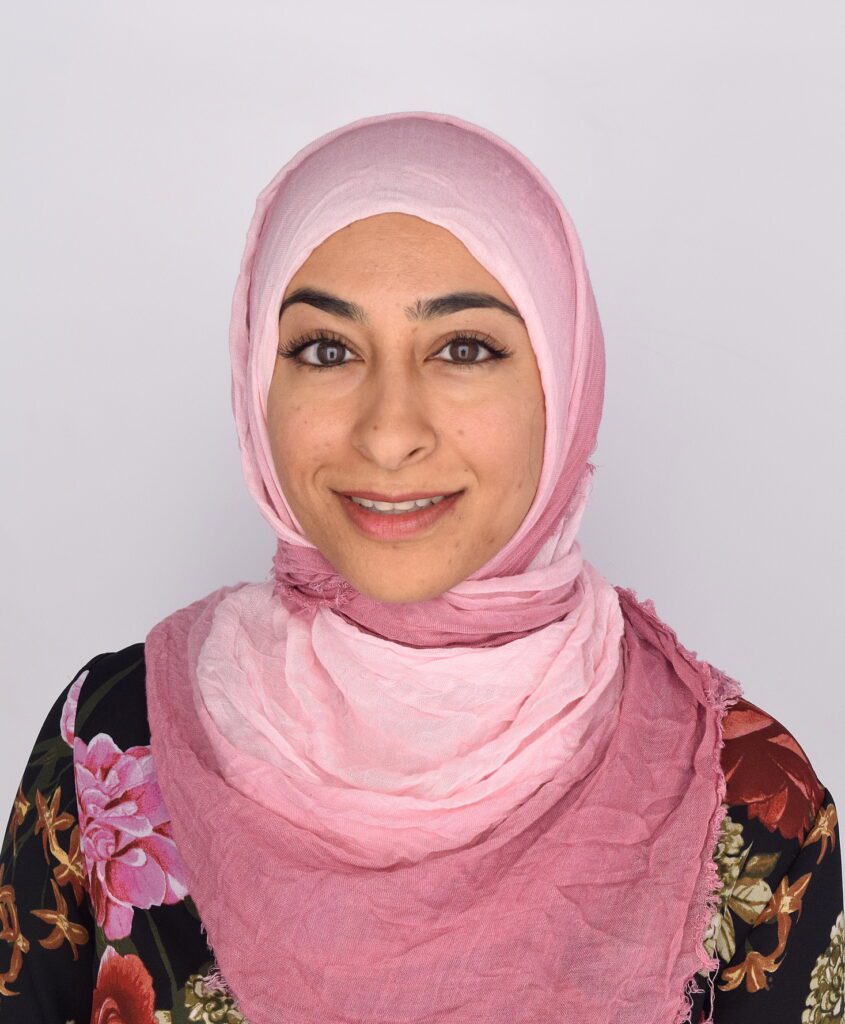 Headshot of Muna Hussaini, an Indian-American woman wearing a headscarf.